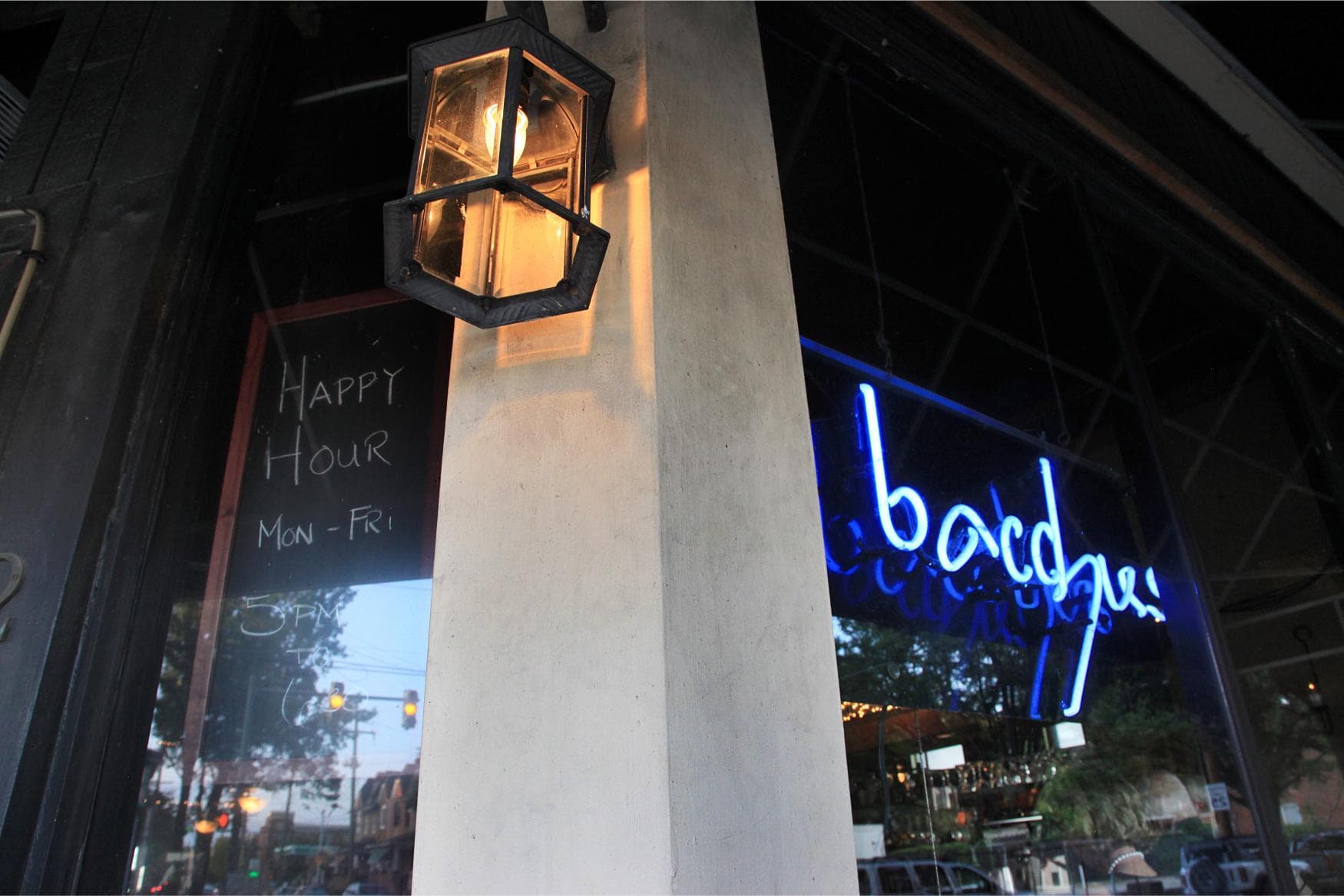 The Bacchus sign and warm lamp light at the corner of Main and Meadow in Richmond's Fan District