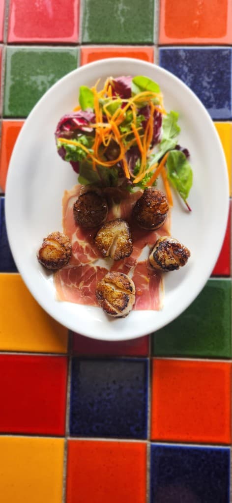 Seared sea scallops with prosciutto and truffle oil at Bacchus, Italian restaurant in Richmond VA